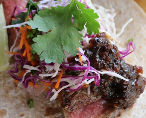 Soft Tortillas with Grilled Spiced Sirloin, Lime Slaw Salad, Ale and Onion Jam